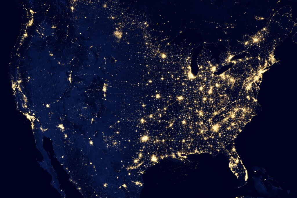 View of the USA from space at night, with cities lit up across the country